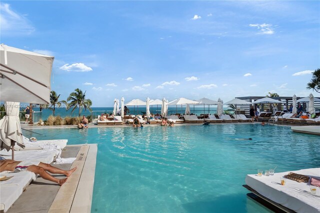 view of pool featuring a water view