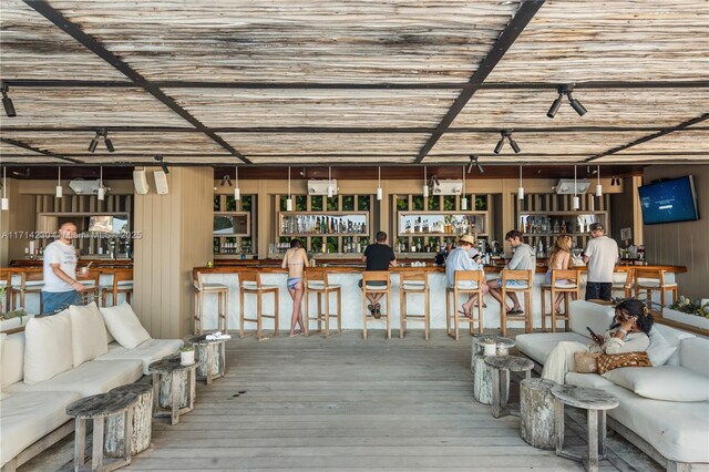 interior space featuring hardwood / wood-style flooring and bar area