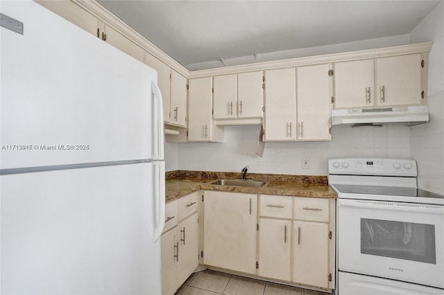 kitchen featuring sink, white appliances, cream cabinets, and light tile patterned floors