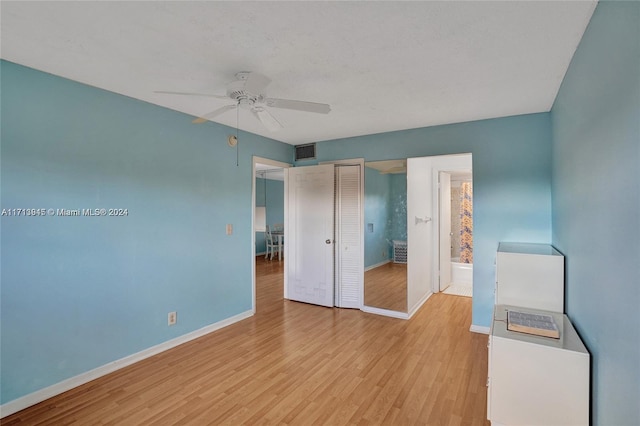 unfurnished bedroom with ceiling fan, light hardwood / wood-style flooring, connected bathroom, and a closet