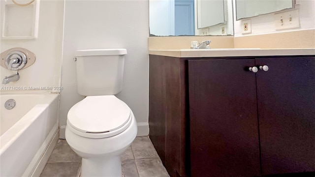 bathroom with tile patterned flooring, vanity, and toilet