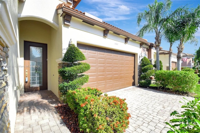 garage with decorative driveway