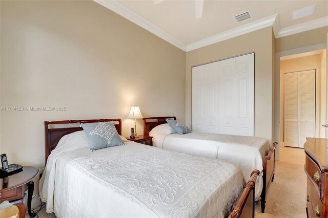 carpeted bedroom featuring a closet, ceiling fan, and ornamental molding