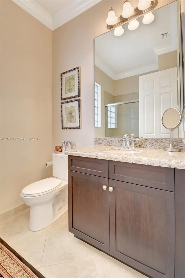 bathroom with vanity, tile patterned floors, toilet, ornamental molding, and walk in shower