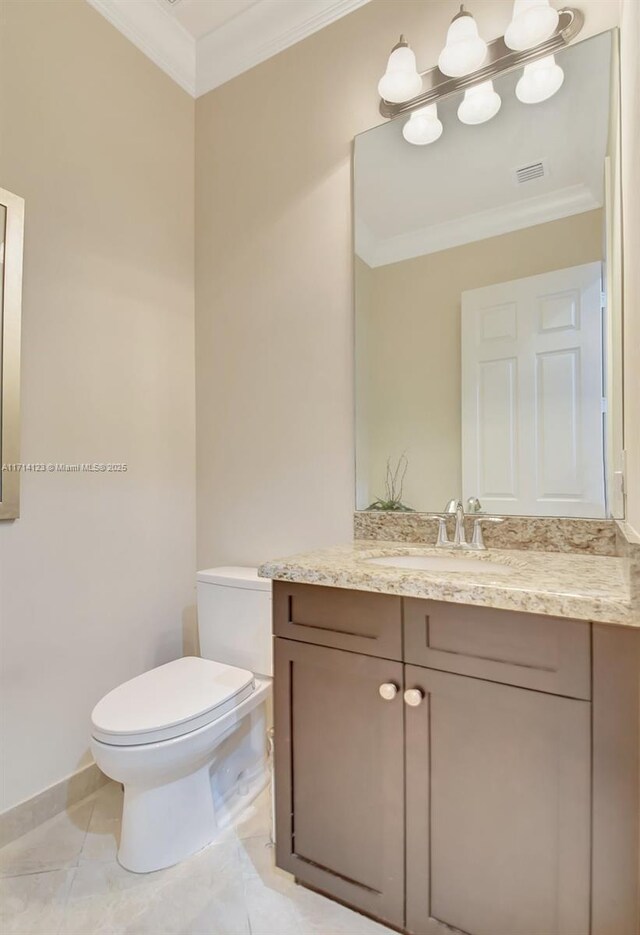 bathroom with tile patterned flooring, vanity, toilet, and ornamental molding