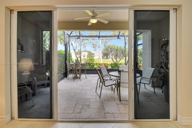 doorway to outside featuring ceiling fan