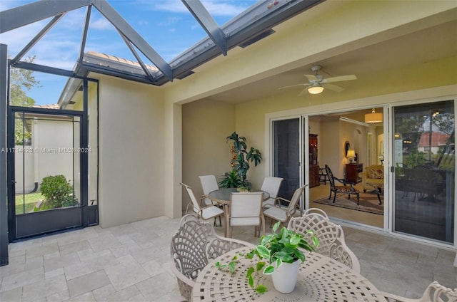 view of patio / terrace with ceiling fan and a lanai