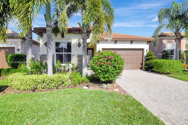 mediterranean / spanish-style house with a front yard and a garage