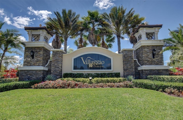 community sign featuring a lawn