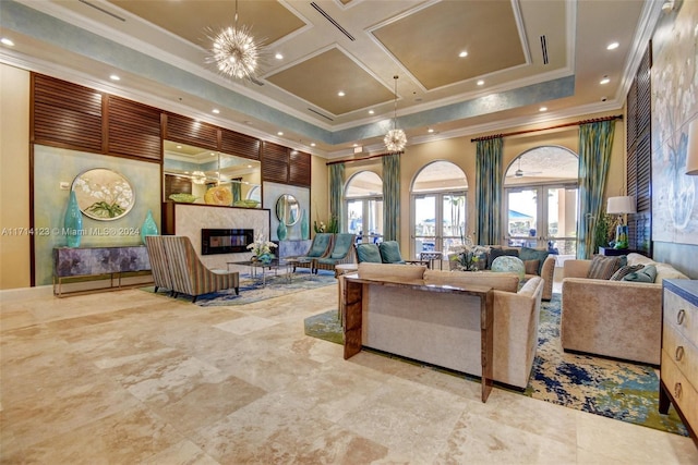 living room featuring coffered ceiling, crown molding, a wealth of natural light, and french doors