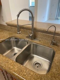 details with stone countertops and sink