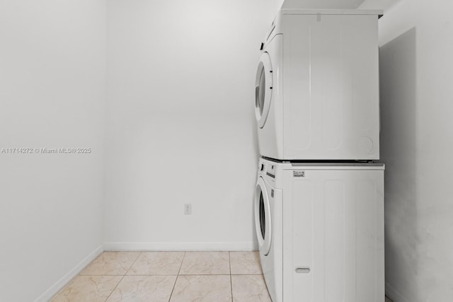 laundry room with light tile patterned floors and stacked washer and clothes dryer