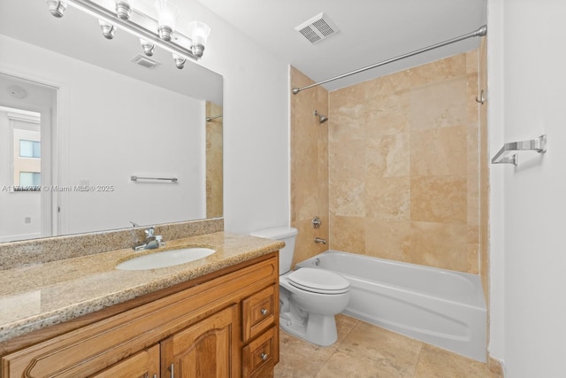 full bathroom featuring tile patterned flooring, vanity, tiled shower / bath combo, and toilet