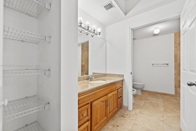 bathroom with vanity, toilet, and a bidet