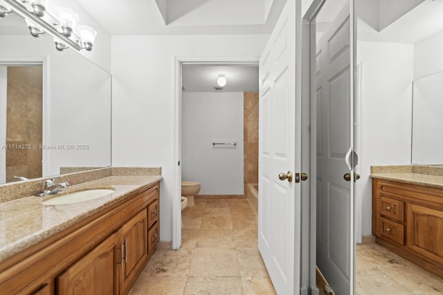 bathroom featuring walk in shower, vanity, and toilet