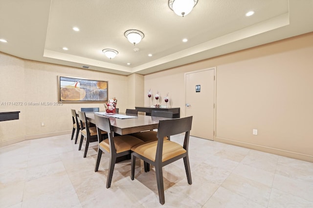 dining space with a tray ceiling