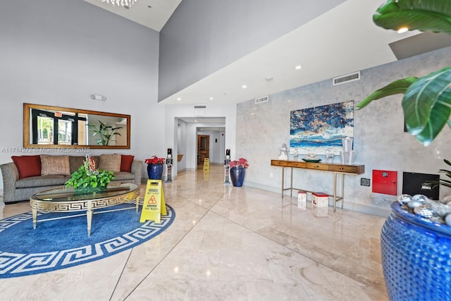 living room featuring a towering ceiling