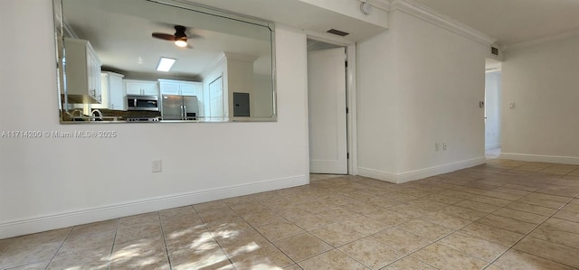 tiled empty room featuring ceiling fan, ornamental molding, and electric panel