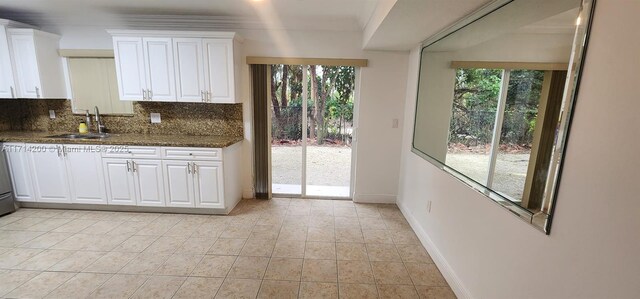 kitchen featuring white cabinetry, sink, and dark stone countertops