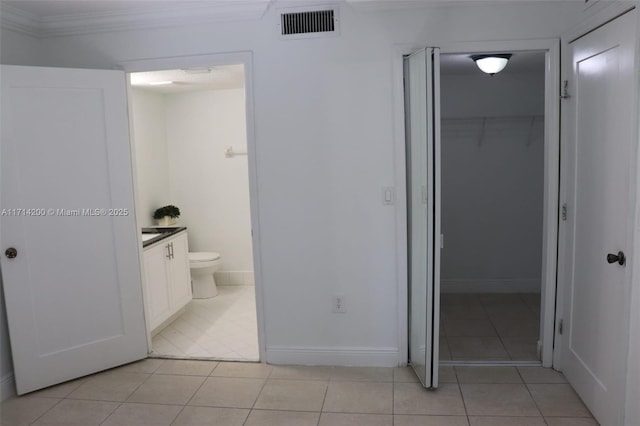 bathroom featuring vanity, crown molding, tile patterned floors, and toilet