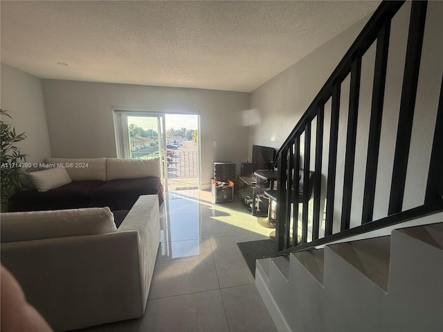 living room featuring light tile patterned flooring and a textured ceiling