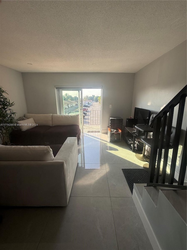 living room featuring tile patterned floors and a textured ceiling