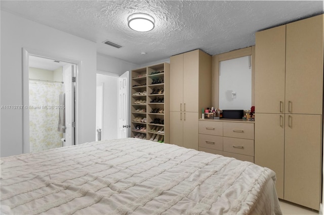 bedroom featuring visible vents and a textured ceiling