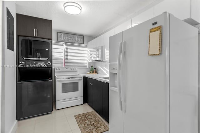 kitchen featuring white appliances, light countertops, a textured ceiling, and light tile patterned flooring