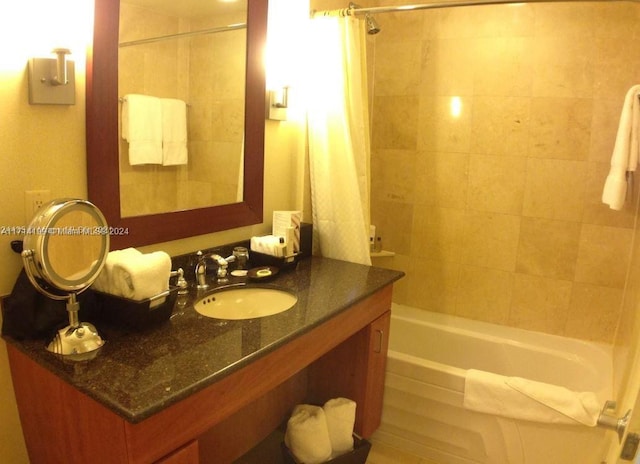 bathroom featuring shower / bath combo and vanity