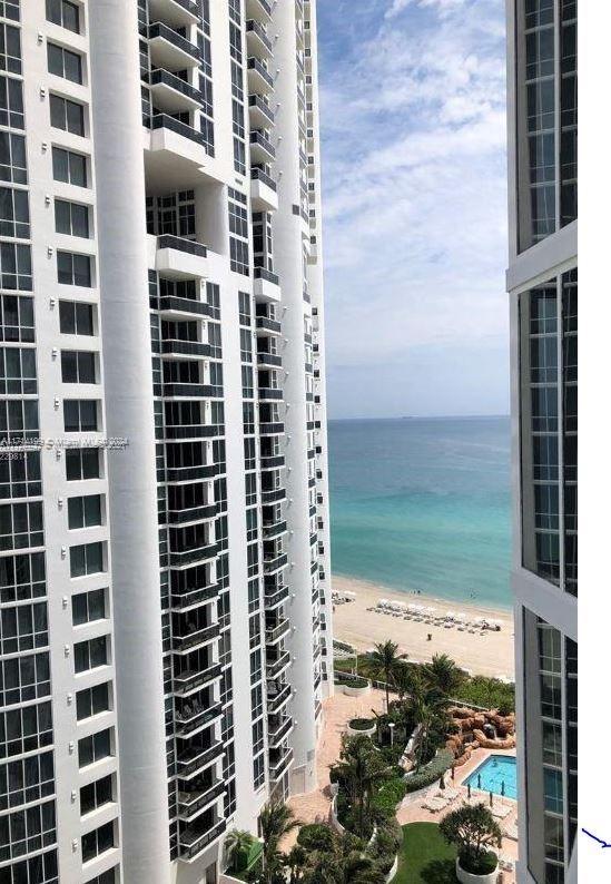 view of building exterior featuring a view of the beach and a water view