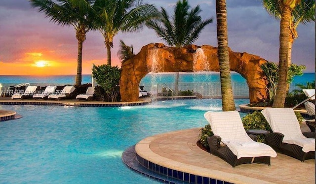 pool at dusk with pool water feature