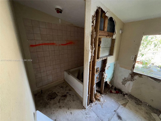 bathroom with a tub to relax in and vaulted ceiling