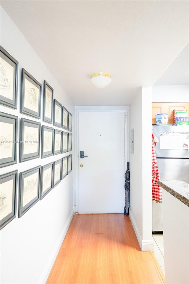 corridor with light hardwood / wood-style floors