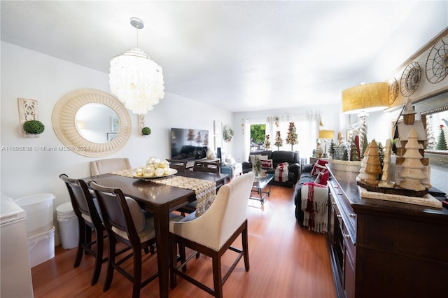 dining room featuring a chandelier and dark hardwood / wood-style floors