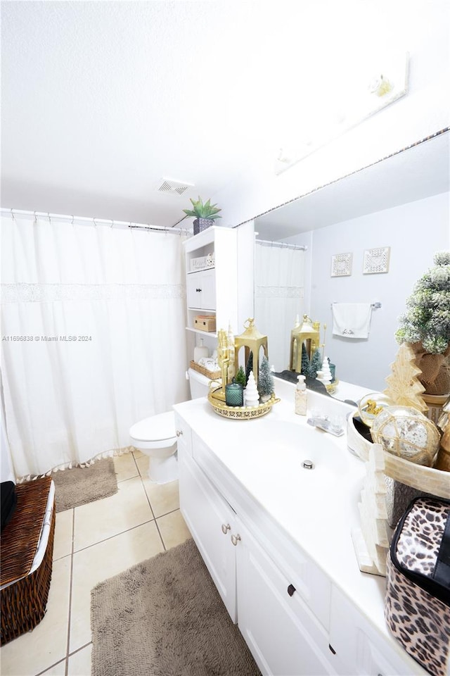 bathroom featuring tile patterned flooring, vanity, and toilet