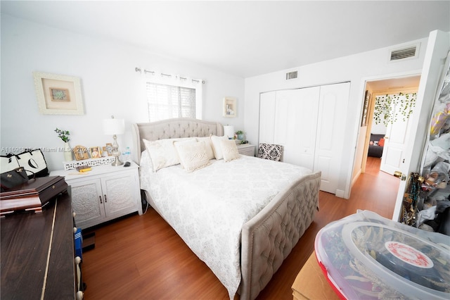 bedroom with a closet and hardwood / wood-style floors