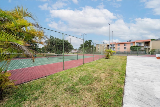 view of sport court featuring a yard