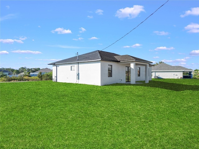 rear view of property with a yard