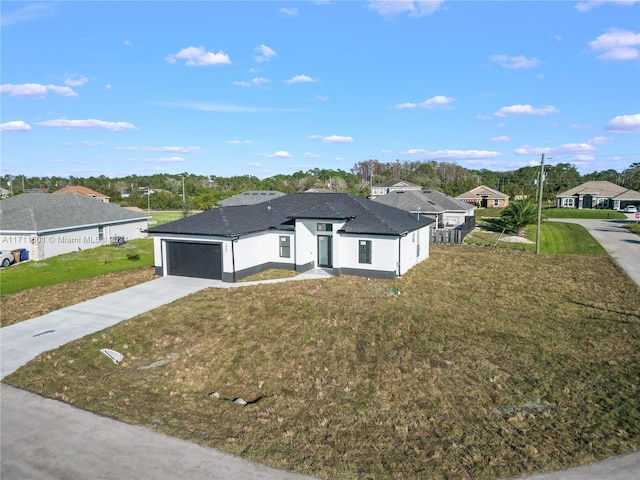 view of front of property featuring a front yard and a garage