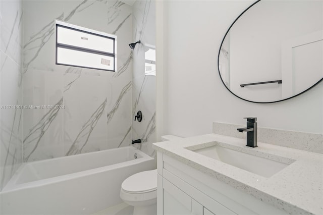 full bathroom with toilet, vanity, and tiled shower / bath