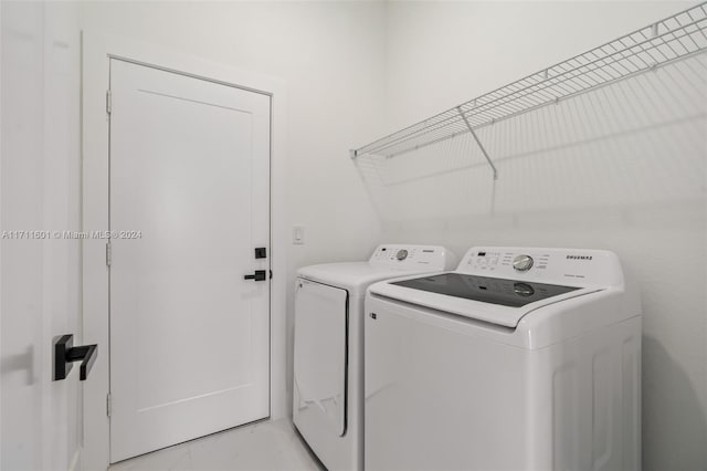 laundry area with light tile patterned flooring and independent washer and dryer