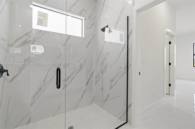 bathroom featuring a shower with door