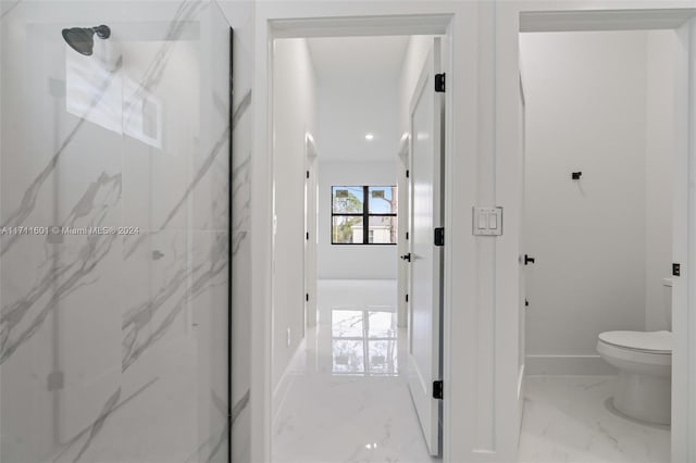 bathroom featuring an enclosed shower and toilet