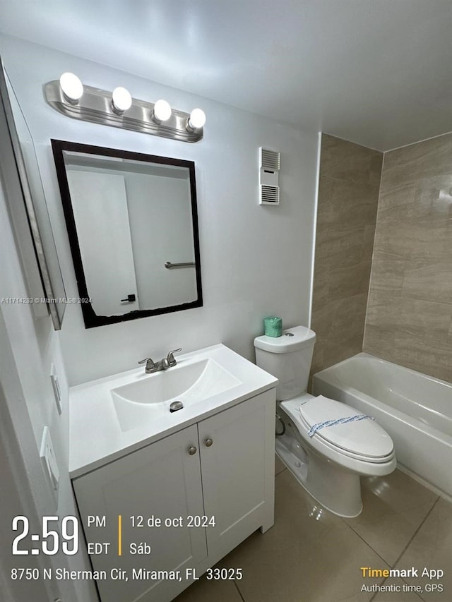 full bathroom with tile patterned flooring, vanity, toilet, and tiled shower / bath