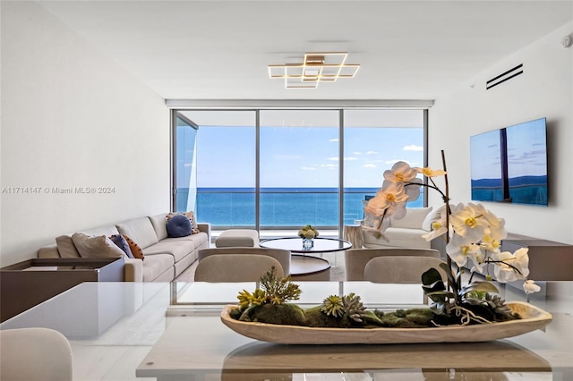 living room with a water view and expansive windows