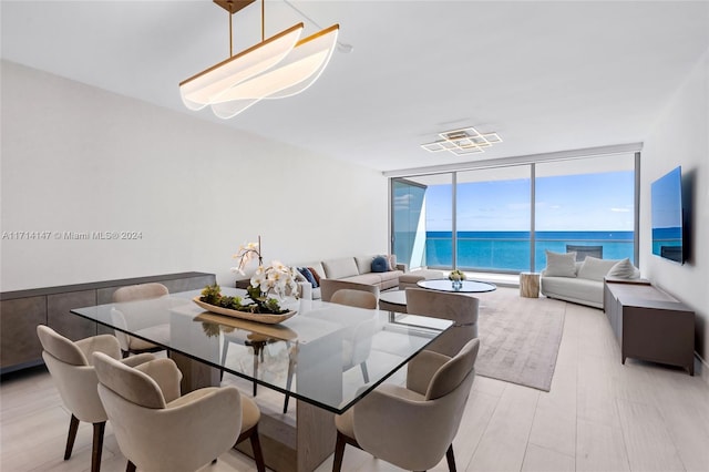 dining space featuring floor to ceiling windows and light hardwood / wood-style floors