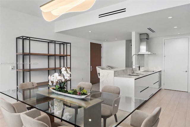 dining room featuring light wood-type flooring and sink