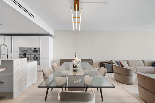 dining area featuring light hardwood / wood-style floors and sink