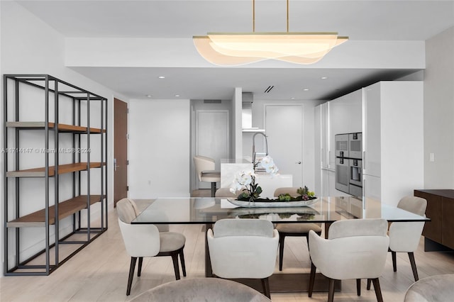 dining space featuring light wood-type flooring