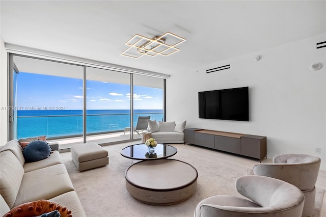 living room with expansive windows and light colored carpet